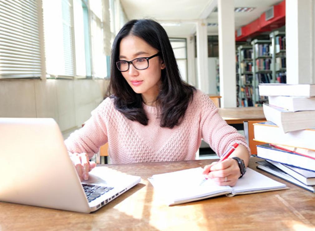 Person pensively using a laptop