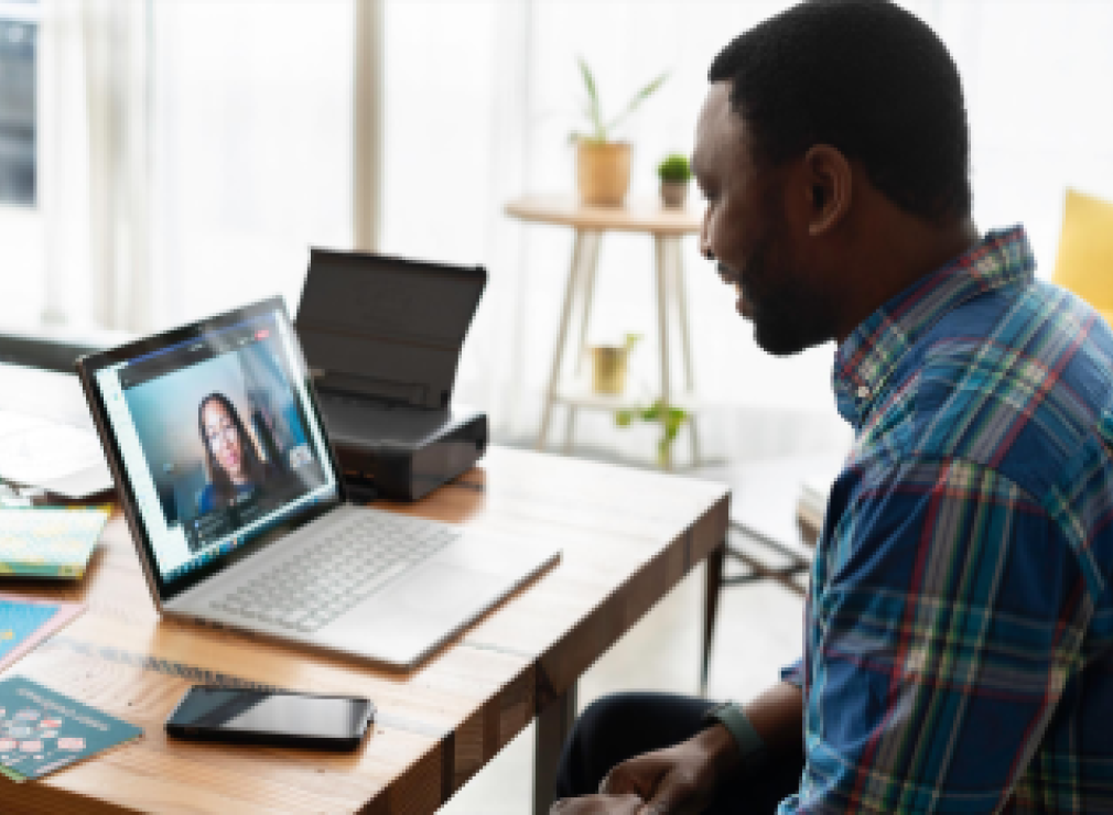 person having a virtual meeting via laptop