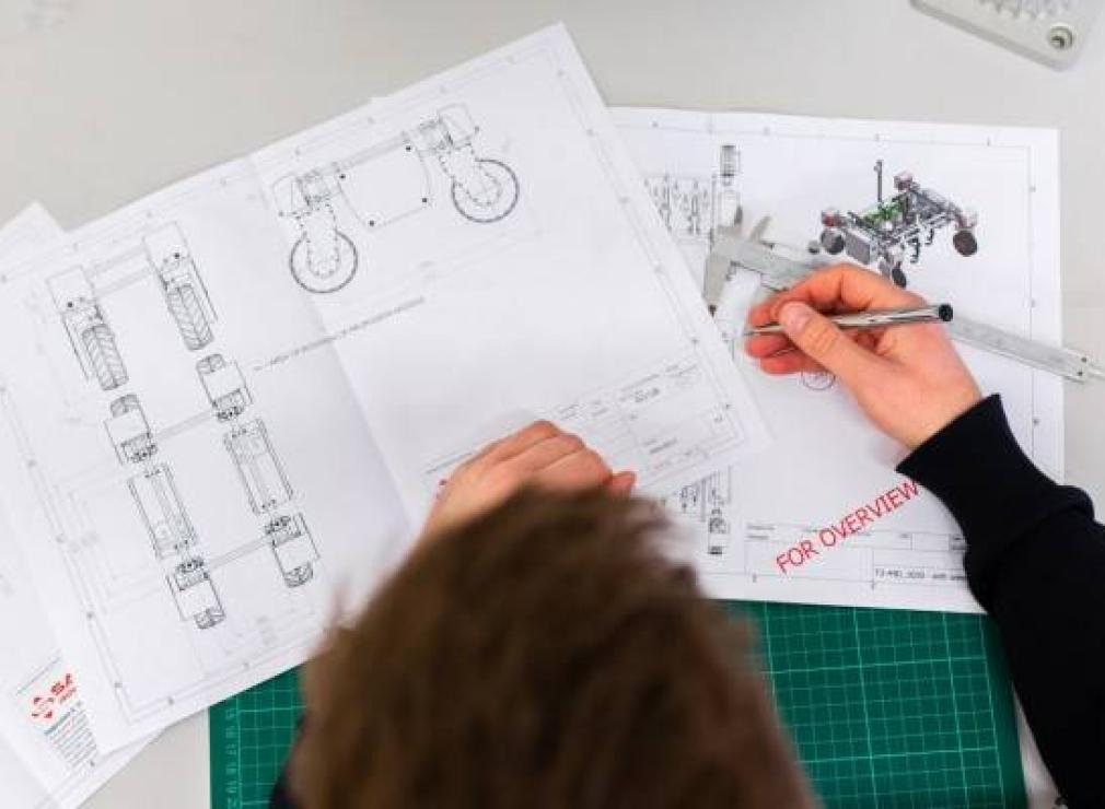 Person sketching some technical diagrams