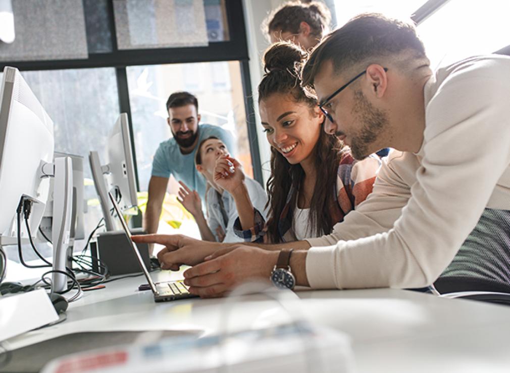 People in office collaborating with enthusiasm