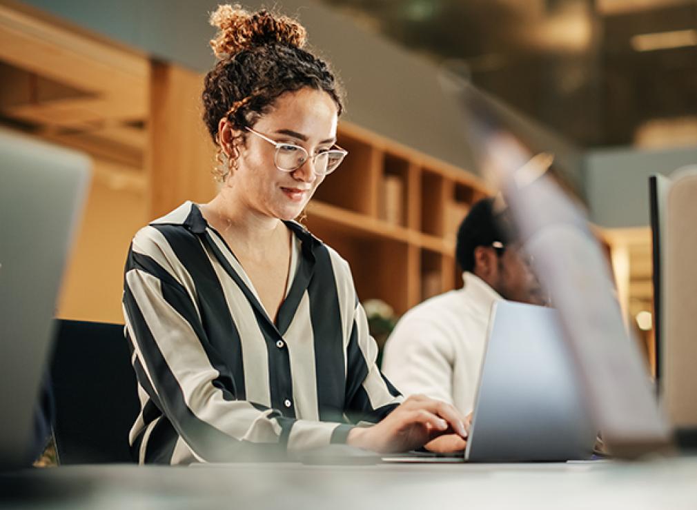 Woman fixated on laptop screen while typing